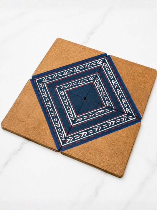 Close-up of a handcrafted square MDF coaster showing the hand-painted geometric design, painted finish, and smooth edges.