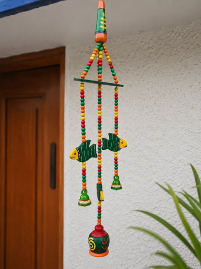 Angled view of the handcrafted ceramic bell hanging displaying its layered decorative construction.
