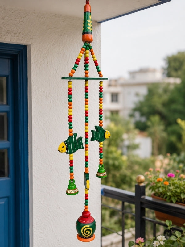 Angled view of the handcrafted ceramic bell hanging displaying its layered decorative construction.
