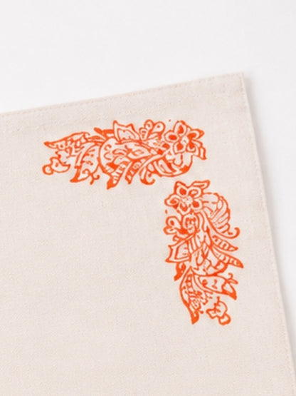 Close-up of the orange floral artwork on the cotton table mat, highlighting the hand-painted brushwork, fabric texture, and stitching.