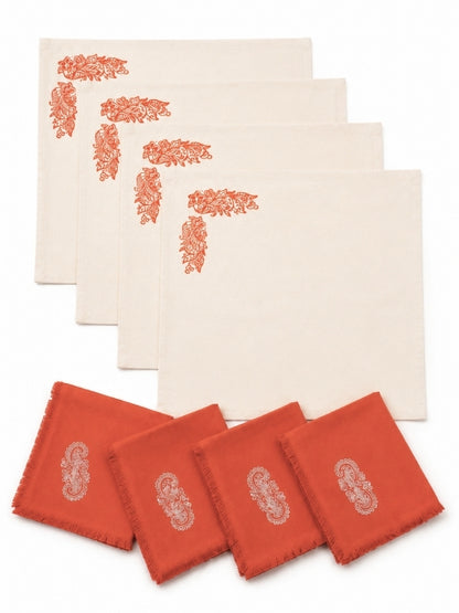 Set of four hand-painted orange floral cotton table mats with four matching napkins displayed together.