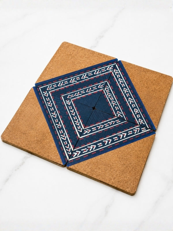 Close-up of a handcrafted square MDF coaster showing the hand-painted geometric design, painted finish, and smooth edges.
