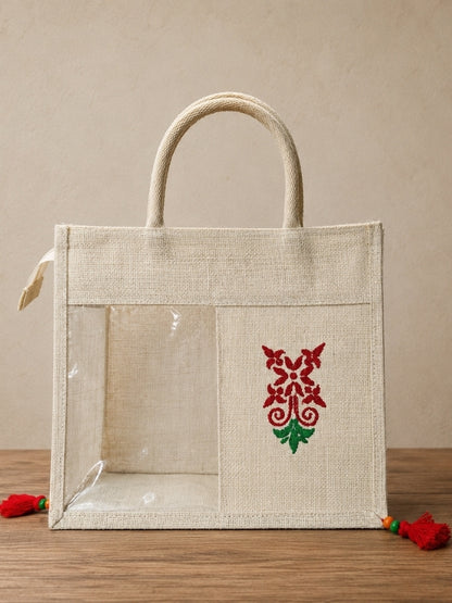 Hand-painted cotton jute tiffin bag measuring approximately 12 inches wide, 10.5 inches high, with a 4-inch side and bottom gusset, featuring a transparent front window, zip closure, and decorative tassel.
