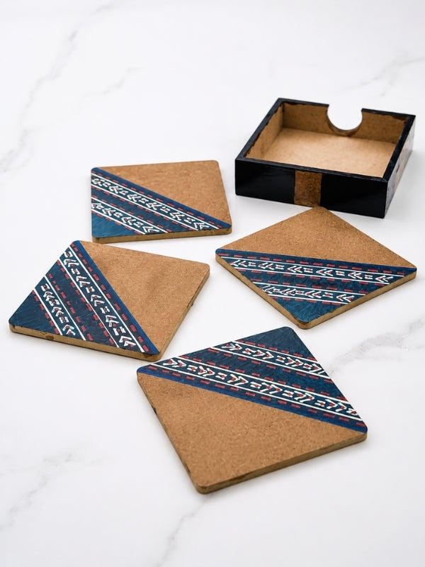 Four handcrafted square MDF coasters with hand-painted geometric designs displayed together