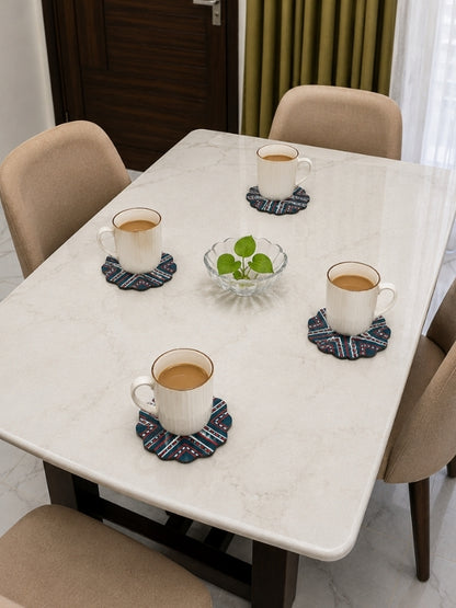 Handcrafted flower-shaped MDF coasters placed beneath cups on a dining table, adding colour and handcrafted charm.