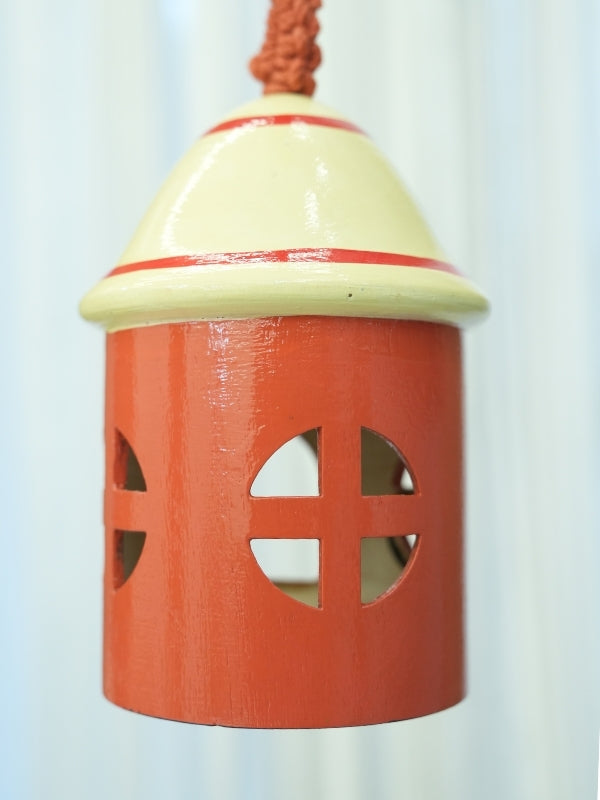 Close-up of the handcrafted bird house tea light holder showing the painted details, cut-out openings, and handcrafted finish.