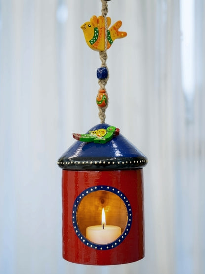 Handcrafted bird house-shaped tea light holder with an alternate hand-painted design, created for use with an electric LED tea light as a decorative home décor accent.