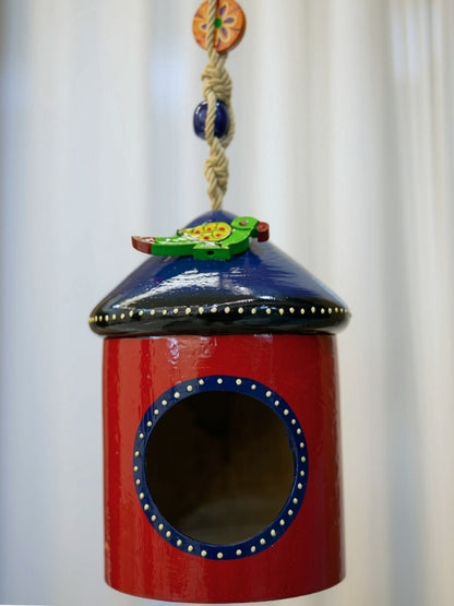 Close-up of the second bird house tea light holder highlighting the handcrafted artwork, painted finish, and decorative cut-outs.