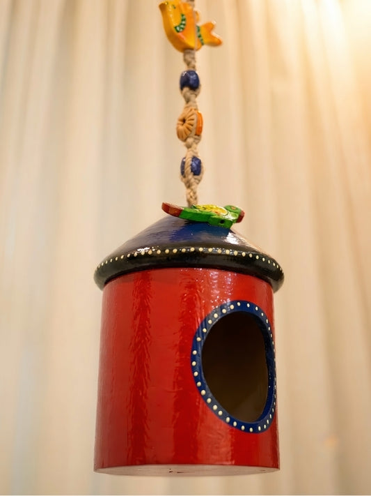 Angled view of the alternate bird house tea light holder showing its handcrafted construction and decorative features.