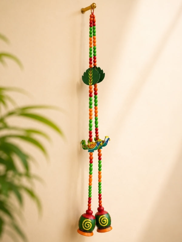 Angled view of the peacock decorative hanging showing its handcrafted structure and decorative detailing.
