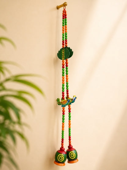 Angled view of the peacock decorative hanging showing its handcrafted structure and decorative detailing.
