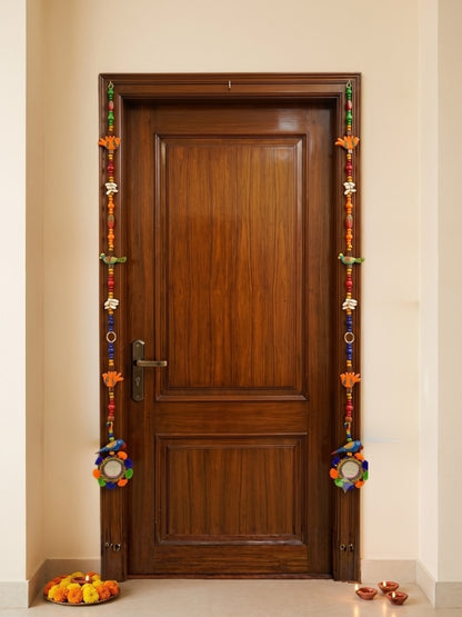 Handcrafted bird decorative hanging displayed on a home entrance, adding colour and warmth to the space.
