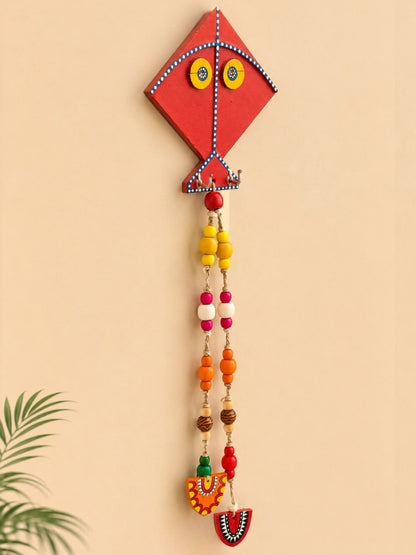 Angled view of the kite key holder displaying its handcrafted construction, hooks, and decorative elements.

