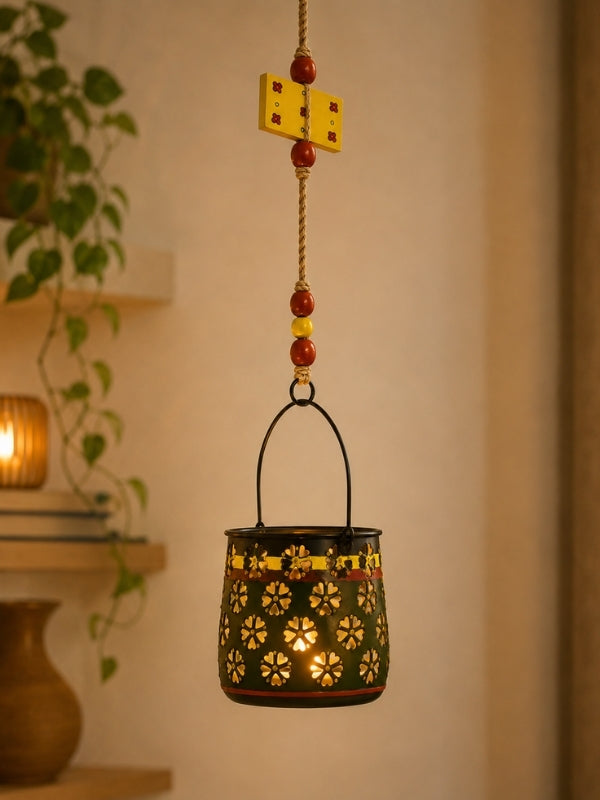 Handcrafted metal tealight holder suspended on a balcony or living room with an electric LED tealight creating a warm decorative glow.