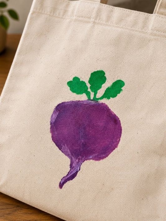 Close-up of the hand-painted beetroot design showing the stencil, canvas texture, and stitching details