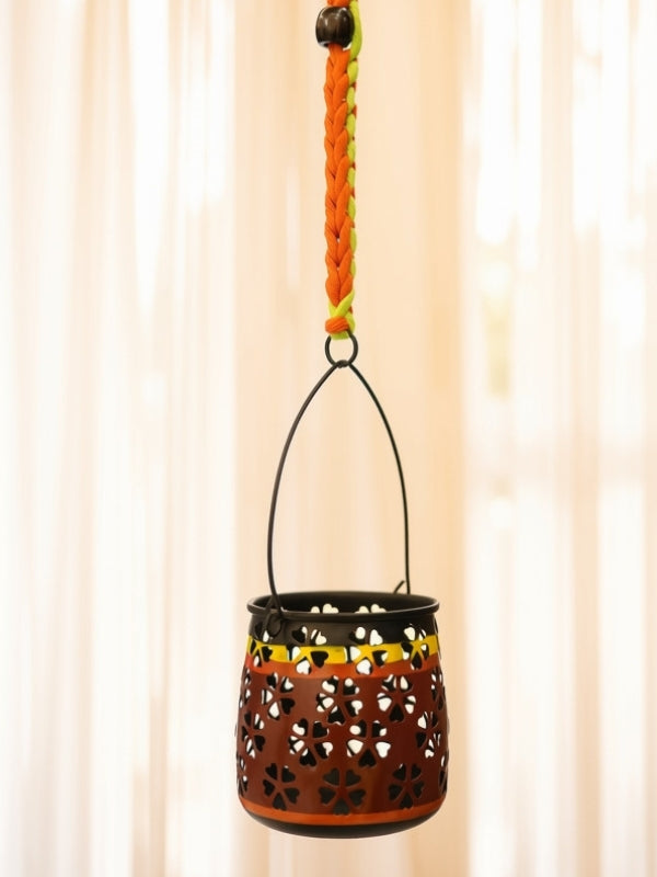 Close-up of the handcrafted metal lantern highlighting the floral cutwork, fine macramé knots, wooden bead detailing, and handcrafted finish.
