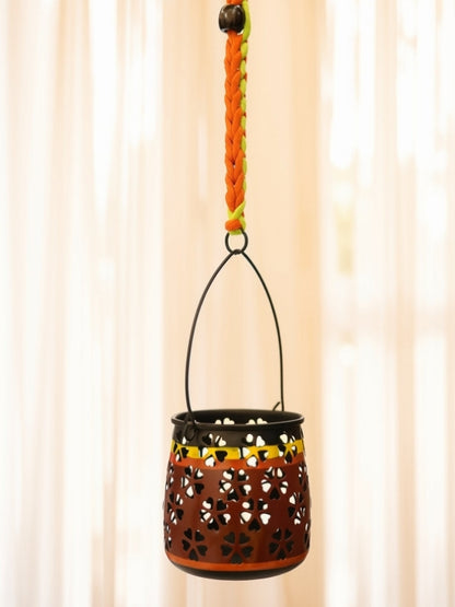 Close-up of the handcrafted metal lantern highlighting the floral cutwork, fine macramé knots, wooden bead detailing, and handcrafted finish.
