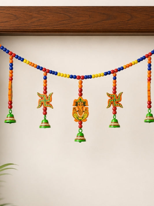 Close-up of the handcrafted Lord Ganesha wall hanging showing the painted details, wood grain, and handcrafted finish.
