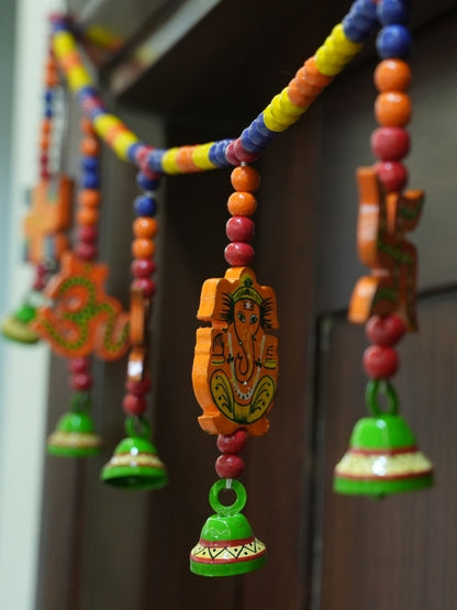 Angled view of the handcrafted Lord Ganesha wall hanging displaying its wooden structure and decorative artwork.
