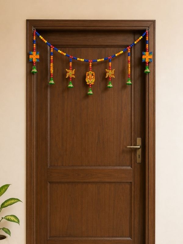Handcrafted Lord Ganesha wall hanging displayed in a pooja corner or home entrance as a decorative accent.
