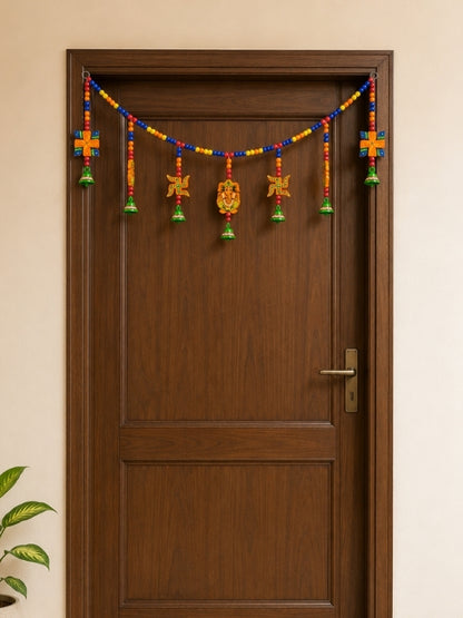 Handcrafted Lord Ganesha wall hanging displayed in a pooja corner or home entrance as a decorative accent.
