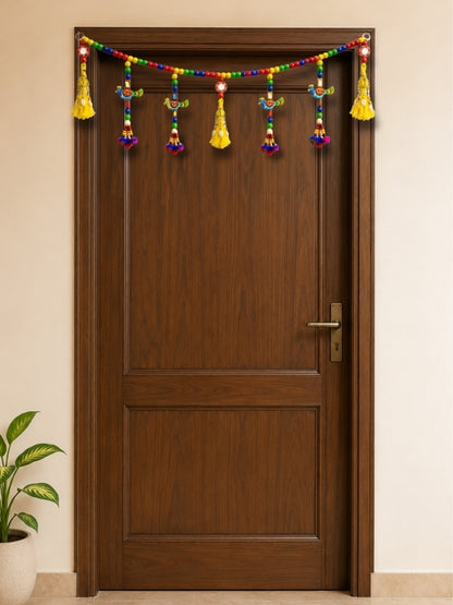 Handcrafted peacock wall hanging displayed on a feature wall, adding colour and artistic character to the home.