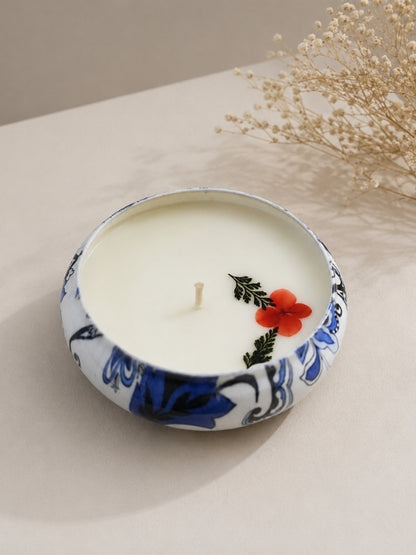 Angled view of the handcrafted botanical soy wax candle showing the floral arrangement and handcrafted finish.