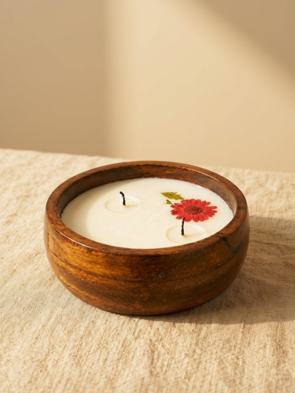 Angled view of the handcrafted decorative soy wax candle showing its floral embellishments and handcrafted finish.