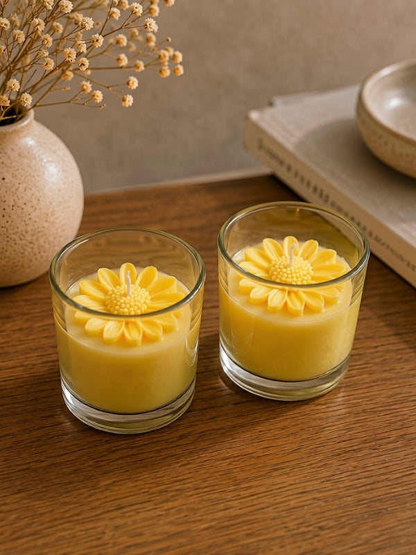 Angled view of the handcrafted yellow soy wax candle displaying the floral decoration and handcrafted finish.
