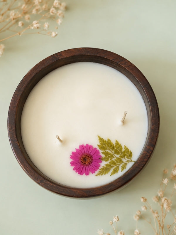 Close-up of the handcrafted soy wax candle highlighting the dried Pink flowers, smooth wax surface, and cotton wick.

