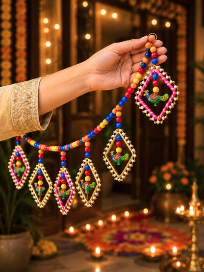 Handcrafted Bandarwal door hanging displayed above a home entrance, adding a traditional and welcoming decorative touch.