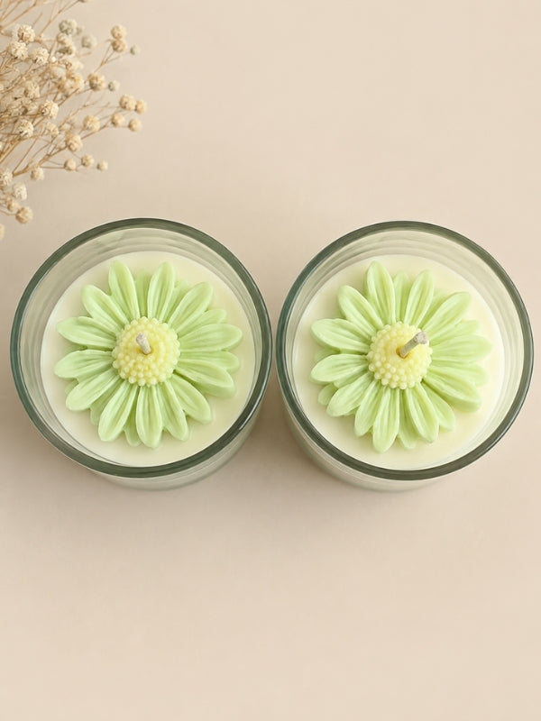 Handcrafted light green soy wax candle decorated with naturally dried flowers, designed for home décor and gifting.
