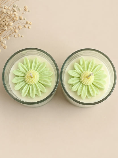 Handcrafted light green soy wax candle decorated with naturally dried flowers, designed for home décor and gifting.
