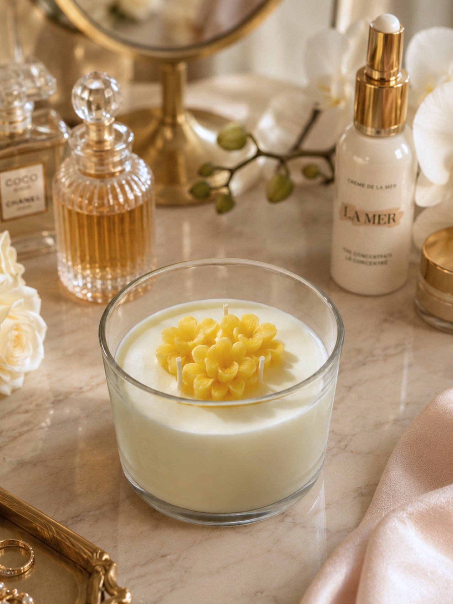 Hand-poured scented soy wax candle in a clear glass jar with a metal lid, measuring approximately 4 inches in diameter and 3 inches in height, featuring decorative wax flowers on the surface.